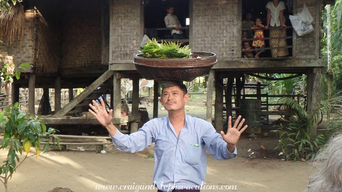 Sandro Win balances a basket on his head, Shwe Lat Pan Village Sandro Win balances a basket on his head, Shwe Lat Pan Village