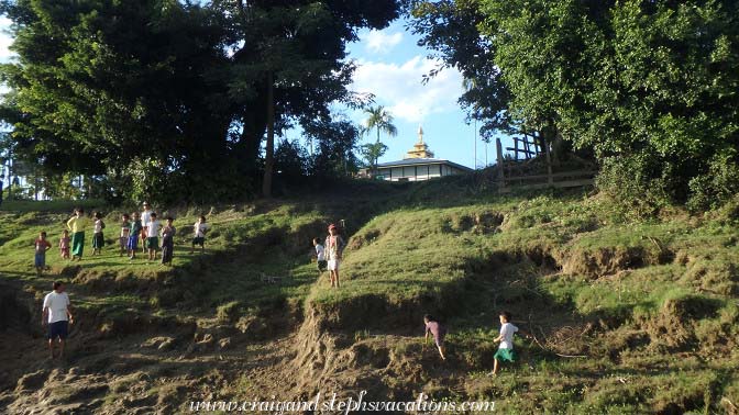 Villagers gather as we approach Tha Phan Seit Village
