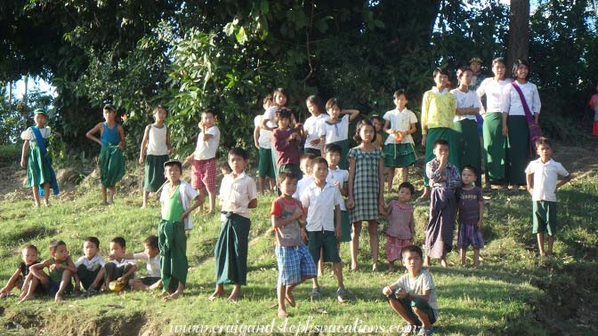 Villagers gather as we approach Tha Phan Seit Village