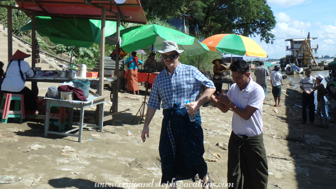 Crew member helps Craig back to the boat on uneven footing