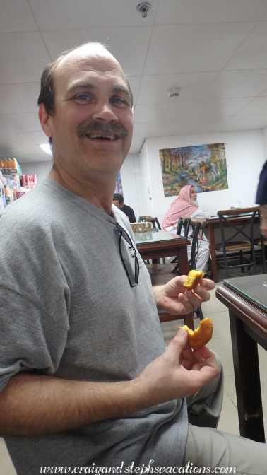 Craig sampling some fritters at Kebab Thayyib